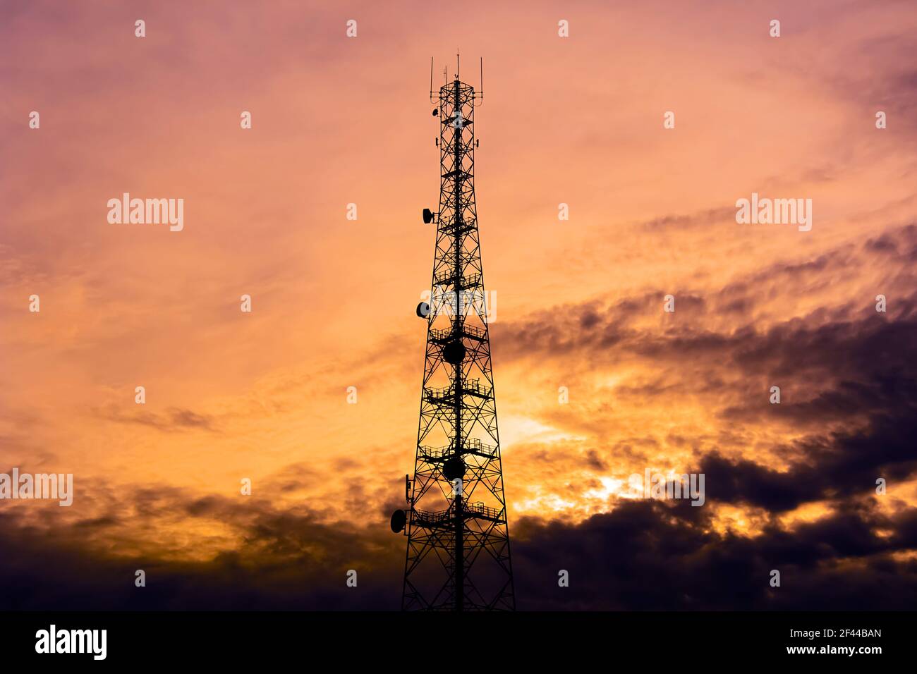 Telecom tower silhouette  in twilight sky background Stock Photo