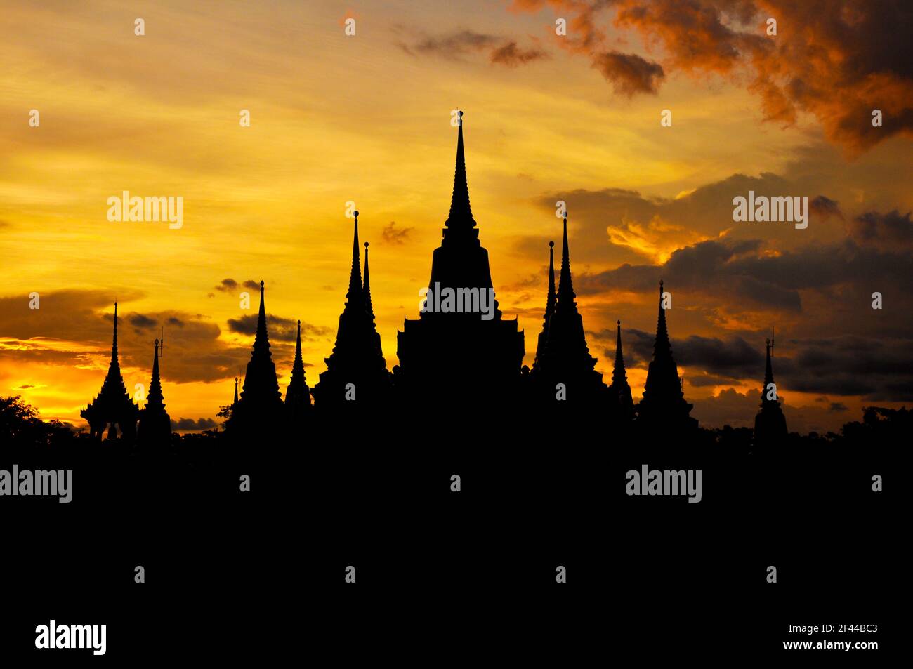 Ancient Thai temple silhouette in twilight sky background - Asian architecture concept Stock Photo