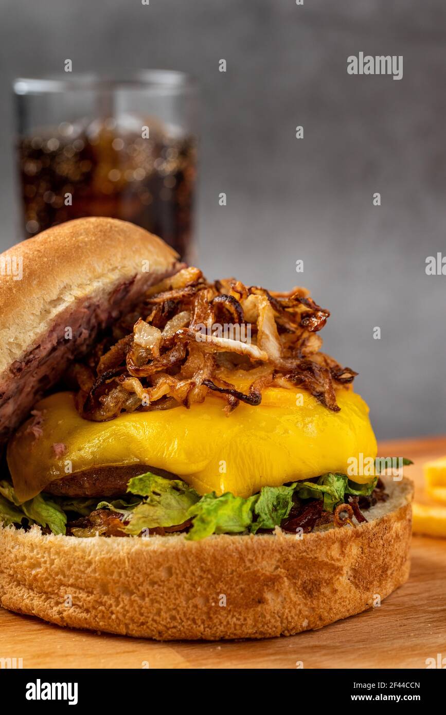 Cheeseburger with caramelized onions. french fries and coke Stock Photo Alamy