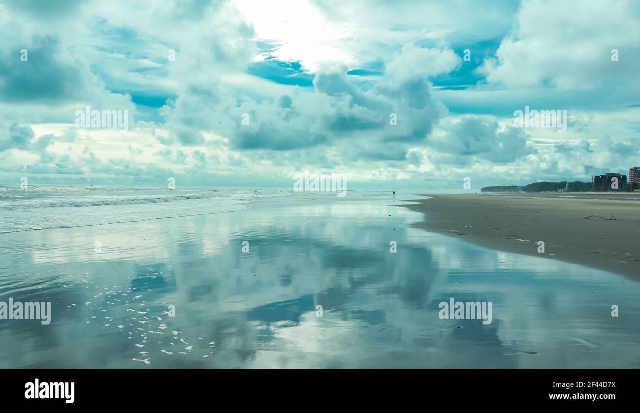 landscape of cox's bazar sea beach . beautiful cloudy sky reflected on wet beach . longest sea beach in the world . Stock Photo