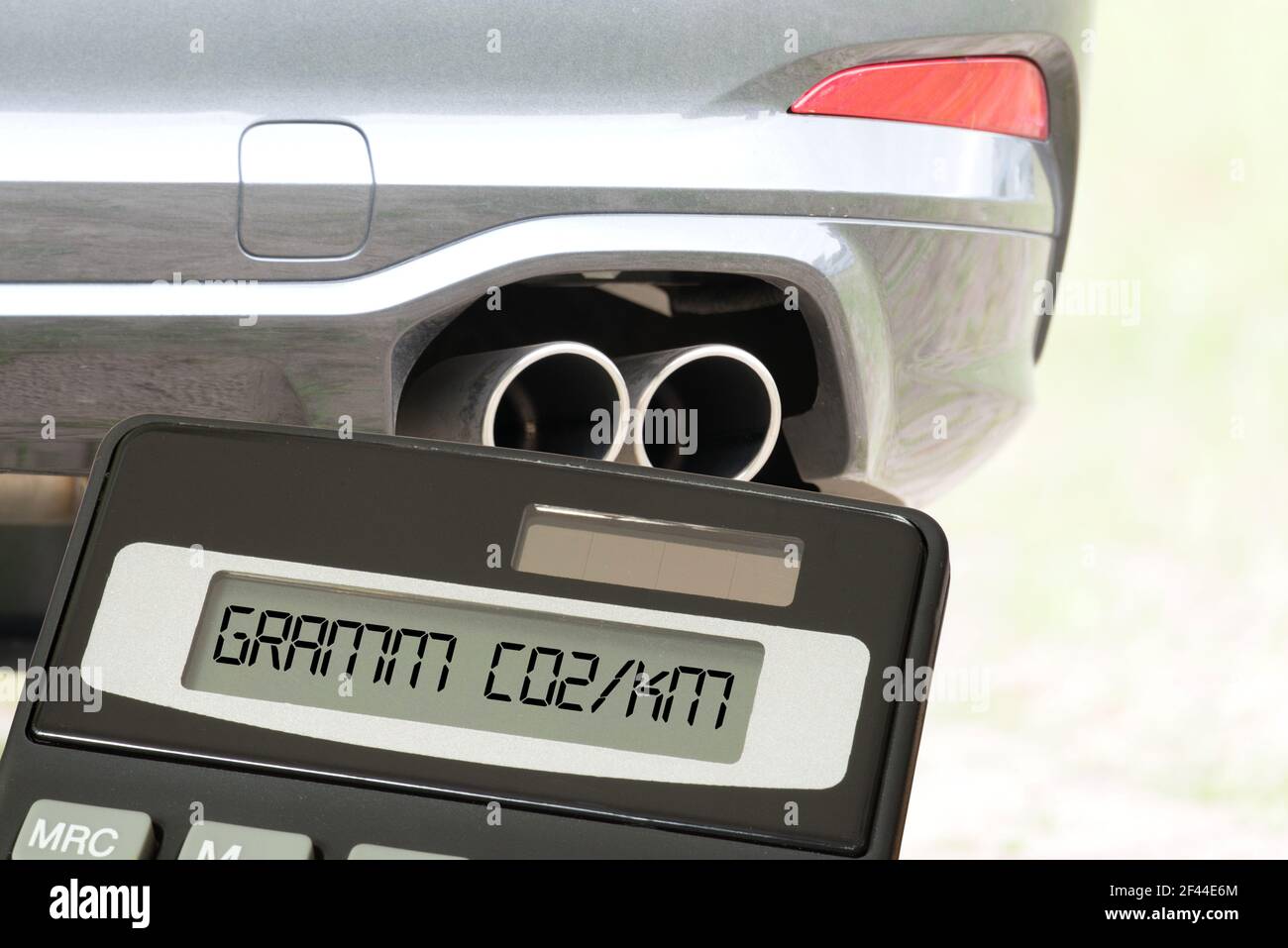 A car, exhaust, calculator and Co2 emissions Stock Photo - Alamy
