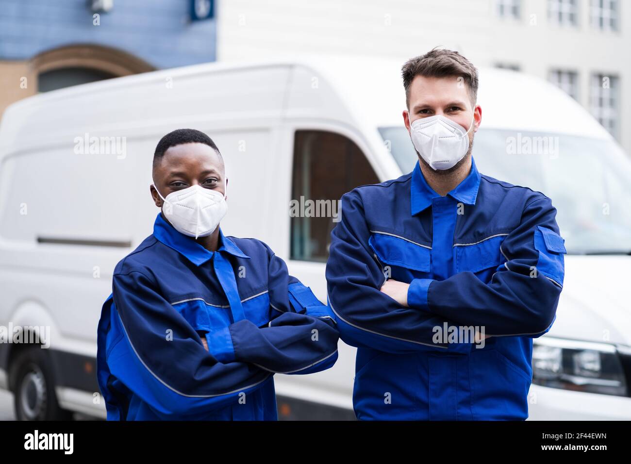 Electrician Technician Or Plumber In Workwear And Face Mask Near Van Stock Photo