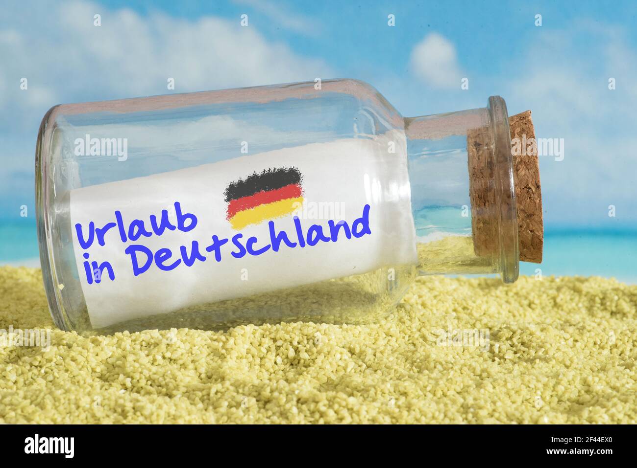 Beach and bottle with the message Vacation in Germany Stock Photo