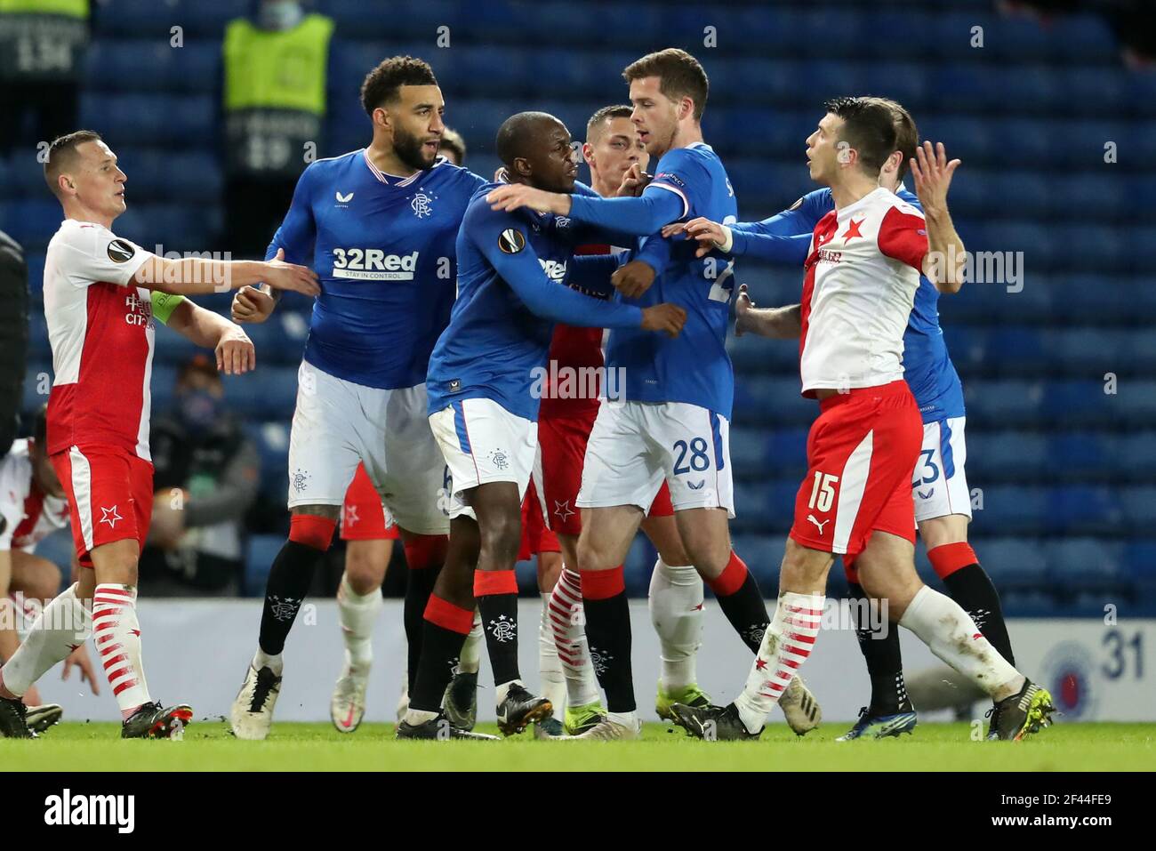 Rangers' Glen Kamara (centre) argues with Slavia Prague's Ondrej Kudela (right) during the UEFA Europa League Round of Sixteen match at Ibrox Stadium, Glasgow. Picture date: Thursday March 18, 2021. Stock Photo