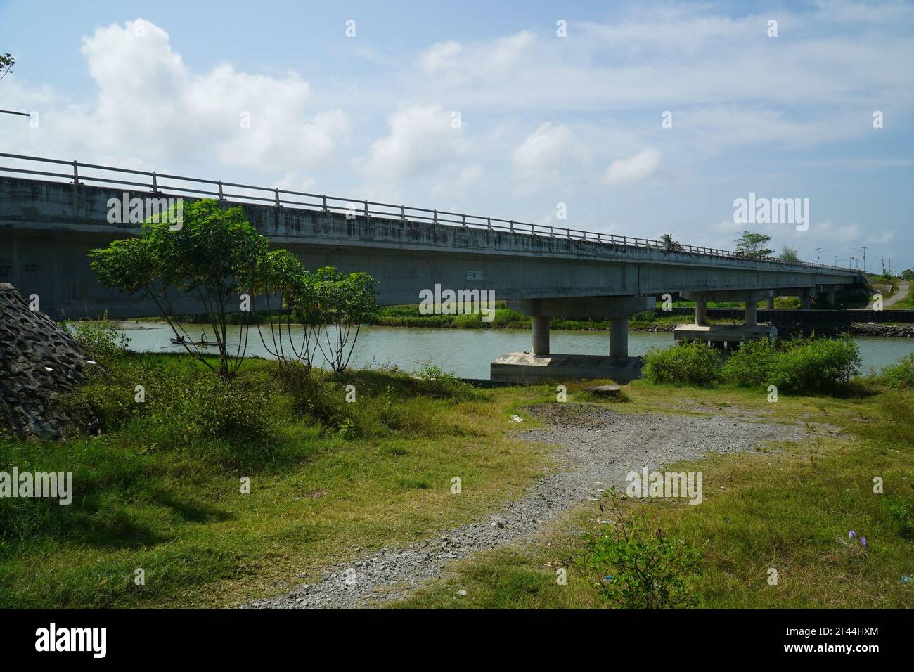 A bridge over a river under a cloudy sky Stock Photo - Alamy