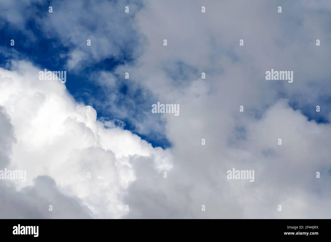 Blue spring sky with clouds with white and gray clouds. Windy March day ...