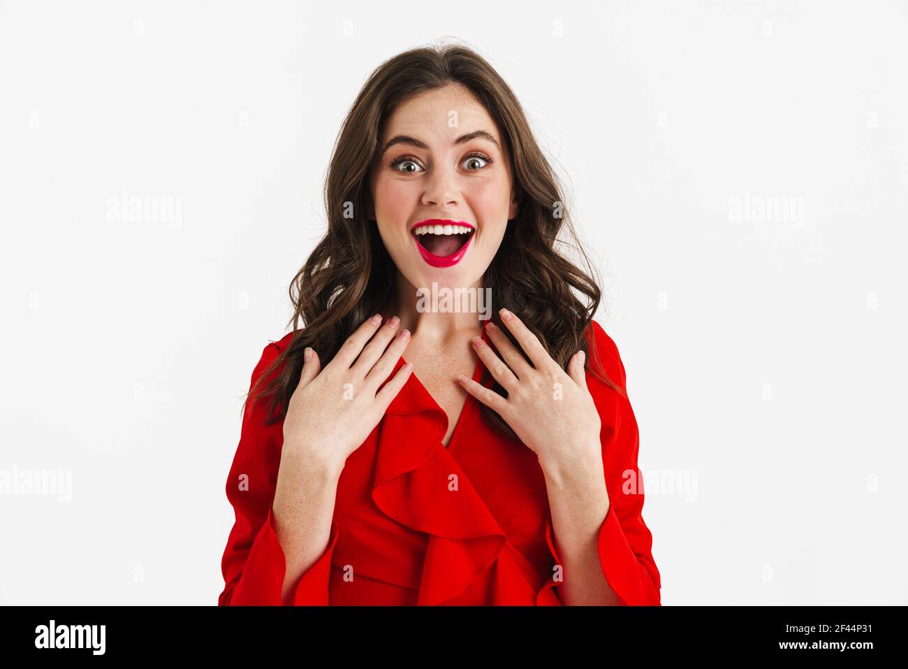 Excited beautiful girl wearing red dress expressing surprise on camera ...