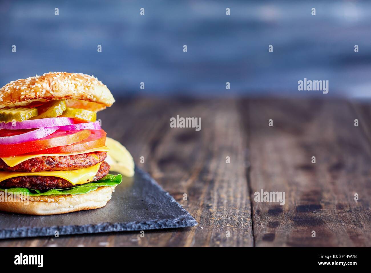 Vegetarian cheeseburger made with two meat substitute patties, slices of melted cheese, onions
