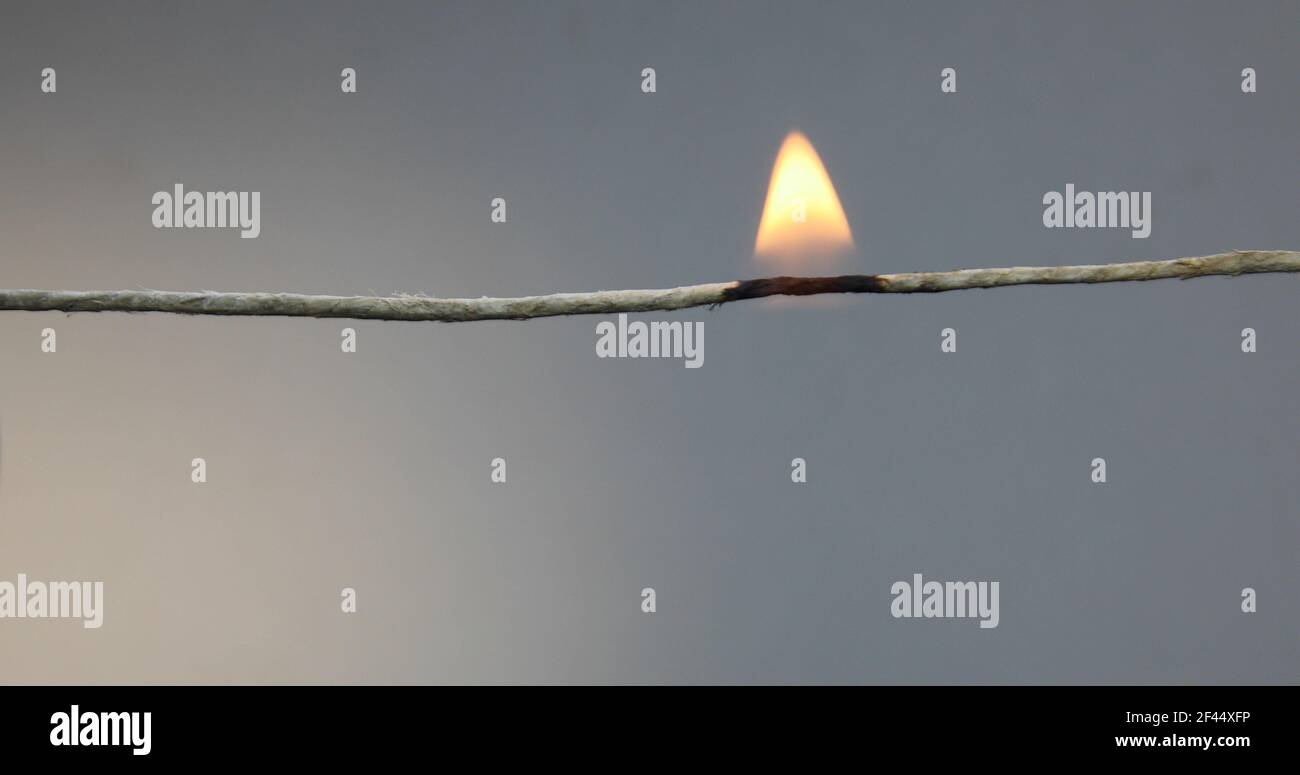 String burns with flame and falls apart Stock Photo - Alamy
