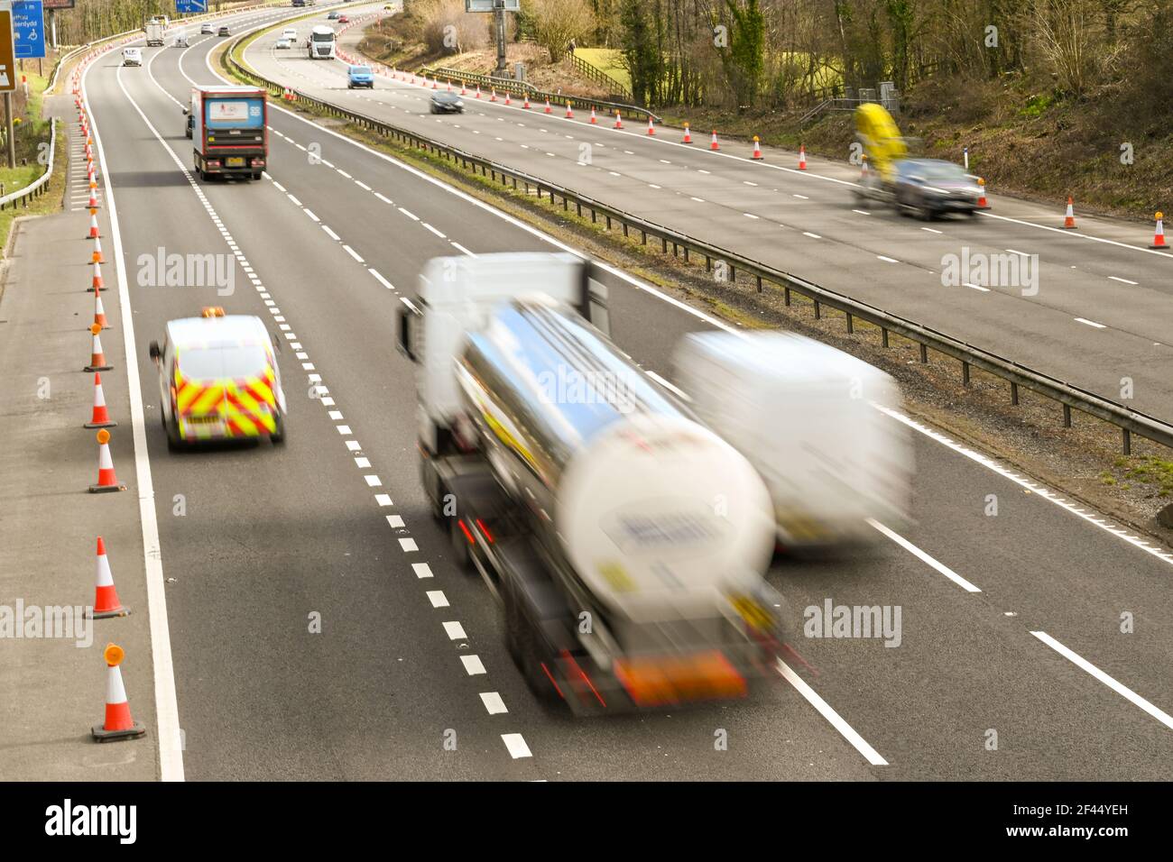 Miskin, Cardiff, Wales - March 2021: Traffic on the M4 motorway near Cardiff. Slow shutter speed used to blur the motion of vehicles to convey speed Stock Photo