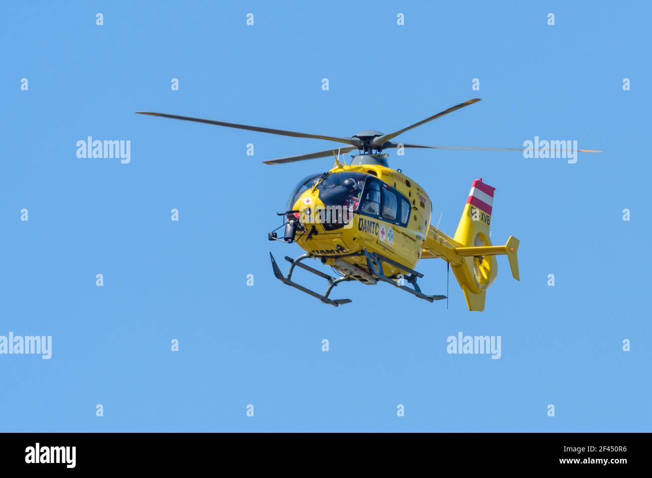 Airbus Helicopters EC 135 T3 operated by Helikopter Air Transport GmbH (Heli Air) OE-XVB, flying in the blue sky Stock Photo