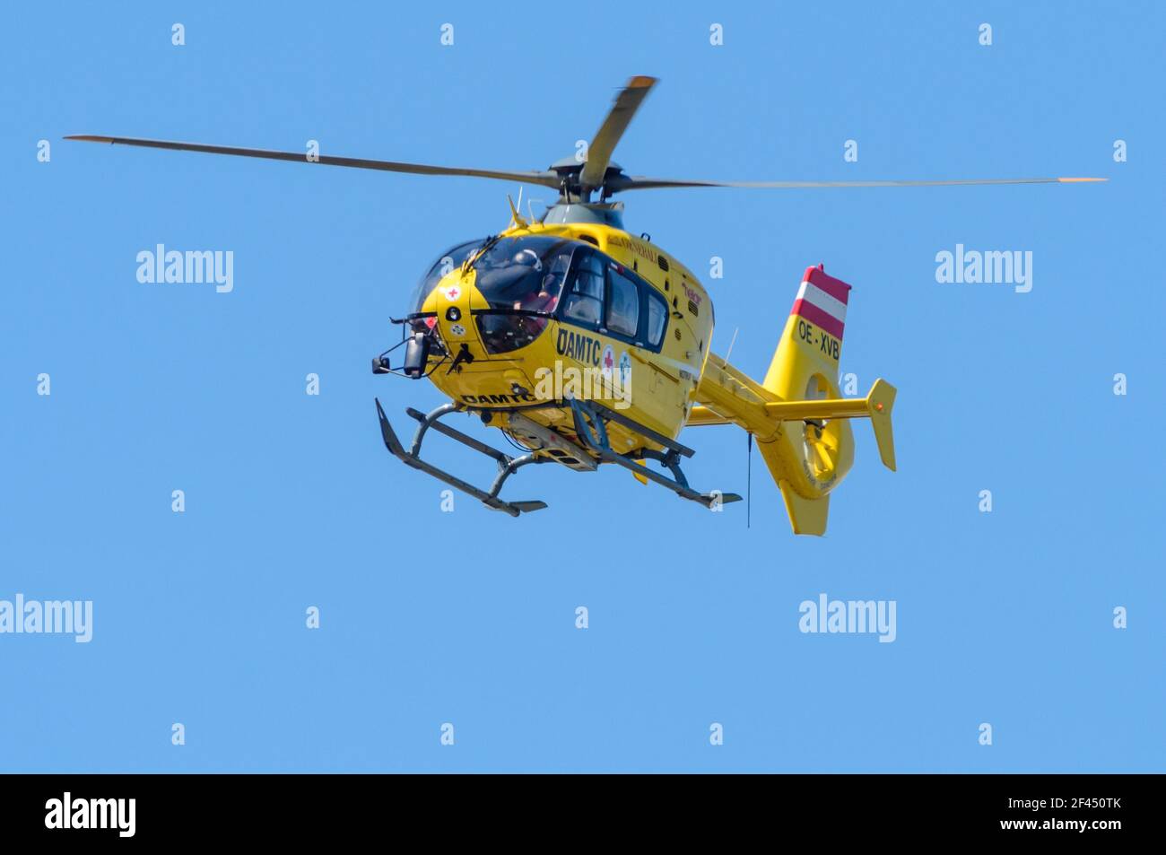 Airbus Helicopters EC 135 T3 operated by Helikopter Air Transport GmbH (Heli Air) OE-XVB, flying in the blue sky Stock Photo