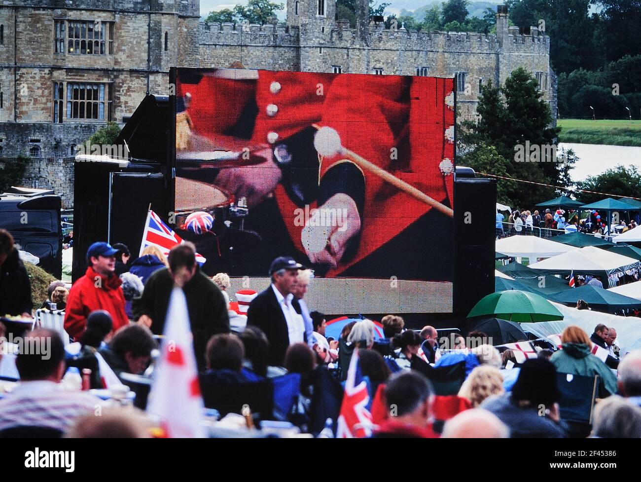 Large digital screen display at an outdoor summer concert at Leeds Castle. Kent. England. UK Stock Photo