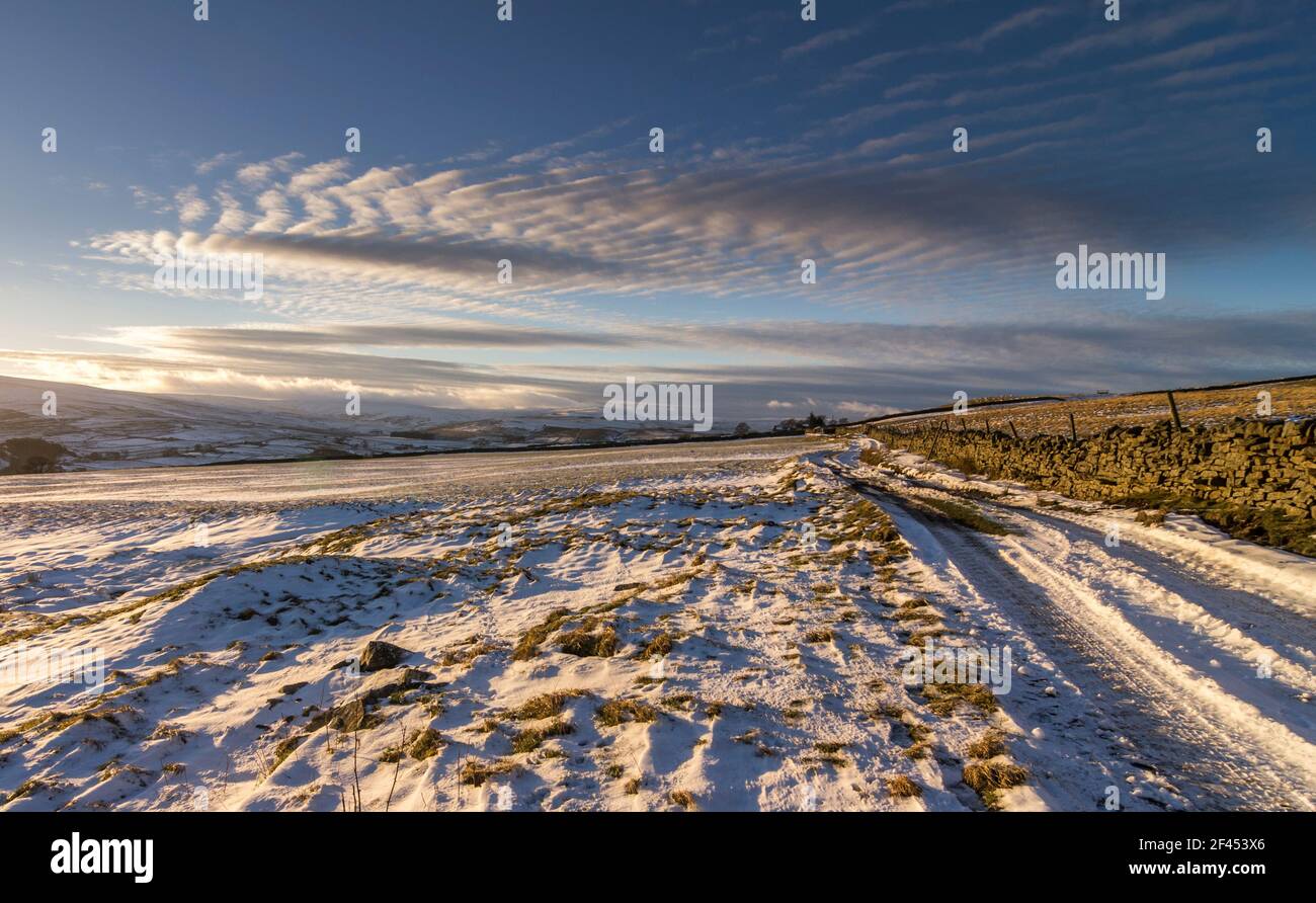 A mackerel sky over a snowy landscape in Weardale, the North Pennines, County Durham, UK Stock Photo