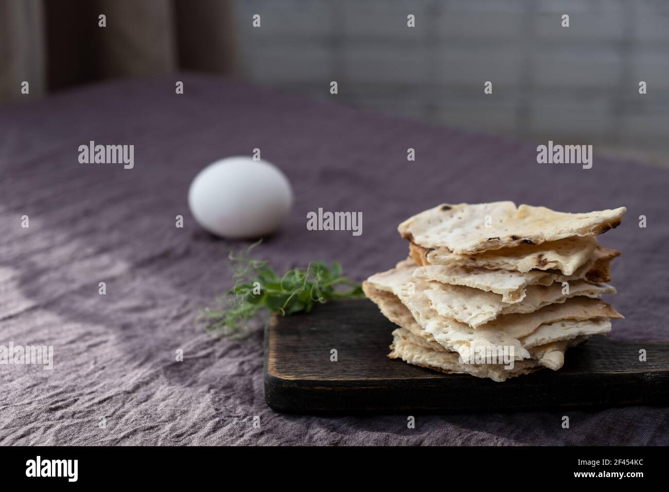 Homemade matzo with microgreen peas. Unleavened flatbread bread. Pesah celebration concept