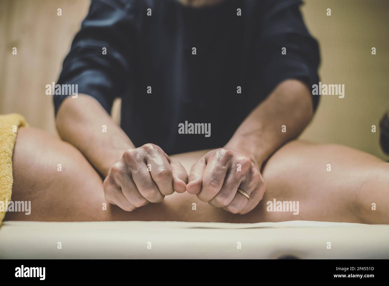 Soft focus view of man massaging a woman in a wellness center. Oiled hands on a body relaxing the muscles and relieve tension.   Holistic exercise Stock Photo