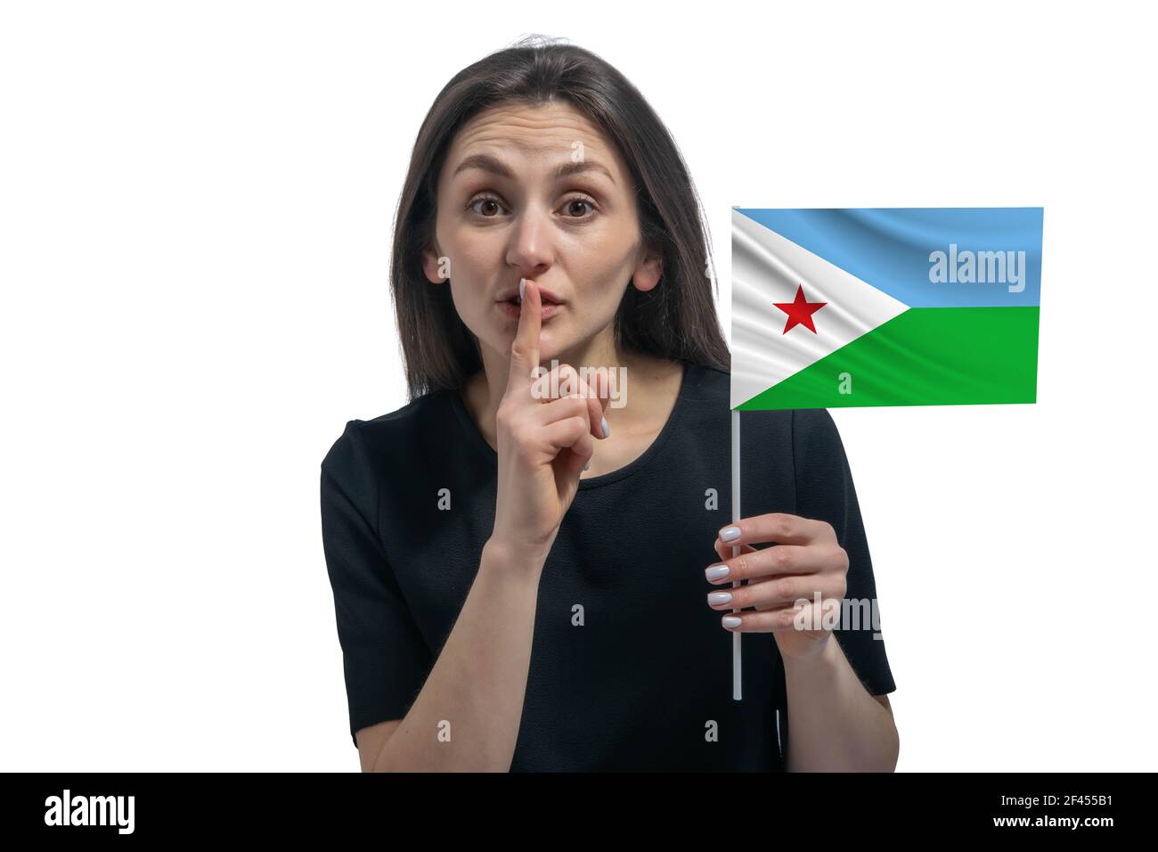 Happy young white woman holding flag of Djibouti and holds a finger to her lips isolated on a white background. Stock Photo