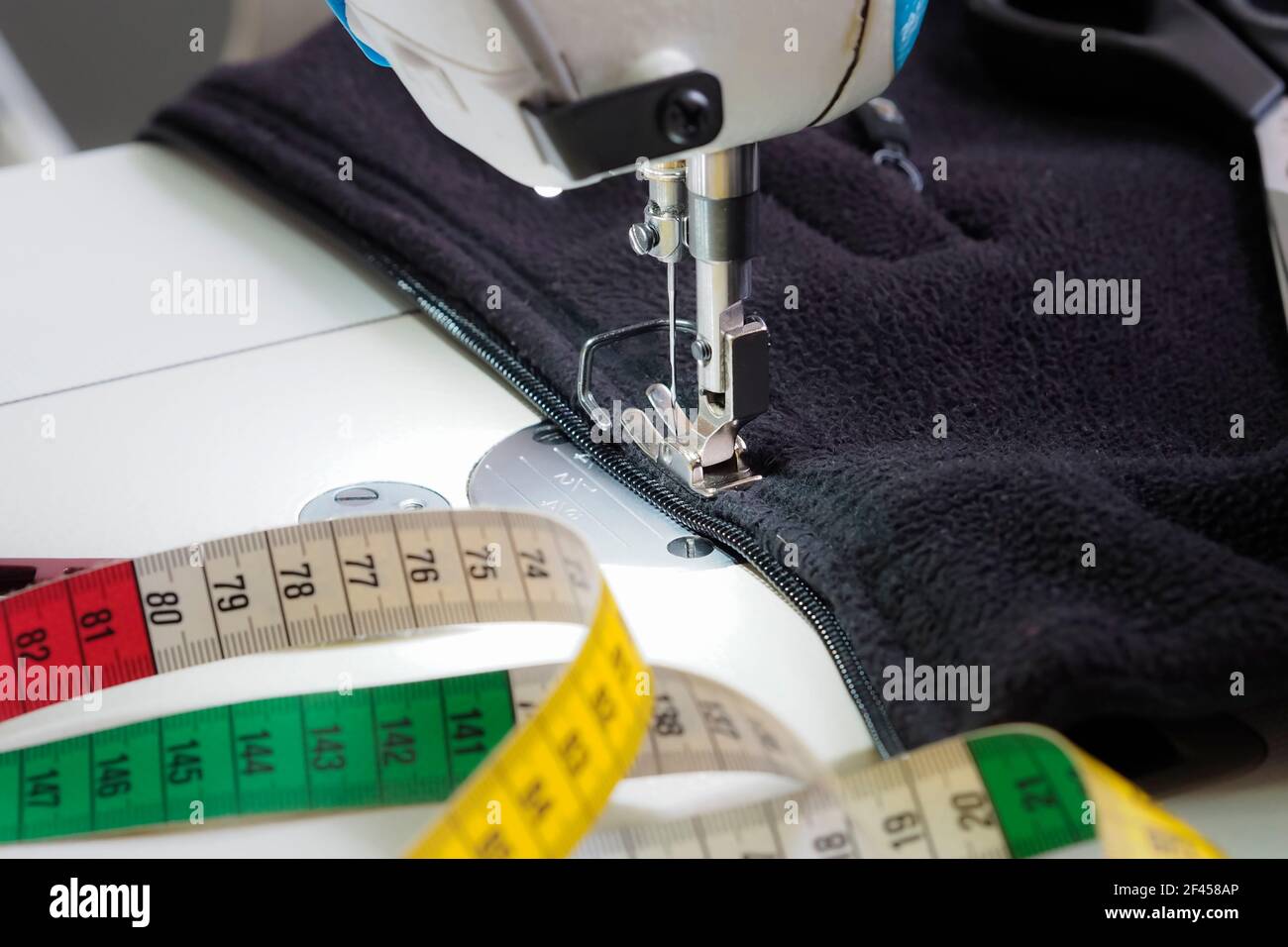 sewing a zipper into a fleece sweatshirt Stock Photo Alamy