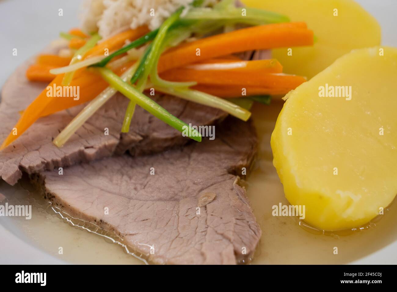 Stewed Pork with Root Vegetable Julienne of Carrots, Leeks, Horseradish and Potatoes called Steirisches Wurzelfleisch in Austria Close Up Stock Photo