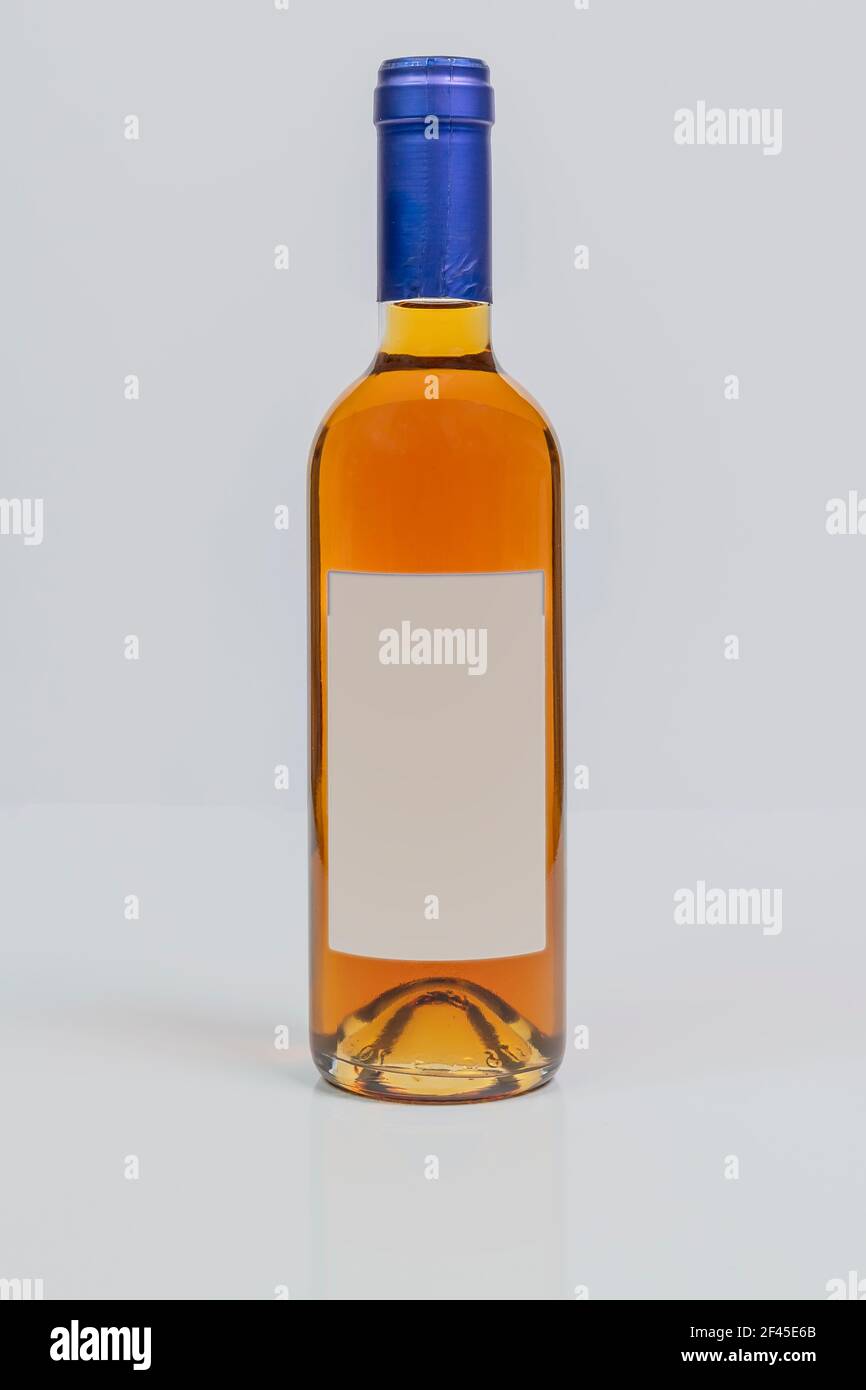 Vin santo wine in super bordeaux style bottle on white surface and background Stock Photo