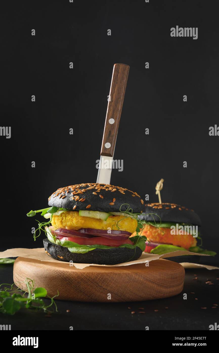 Vegan Burger of black charcoal buns, vegetables, cabbage and carrot