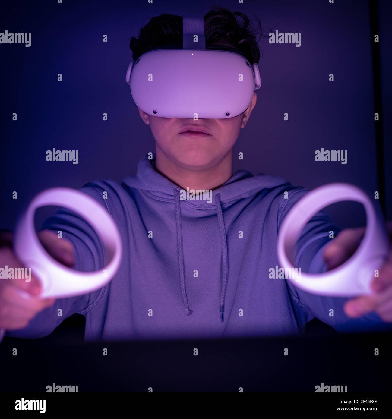 Teenager playing with virtual reality device. Cyberpunk futuristic mood