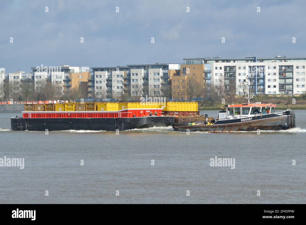Cory Riverside Energy tug REDOUBT heading up the Thames in London towing brand new refuse barge called TYNE Stock Photo