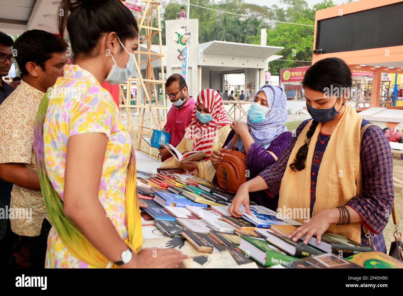 Dhaka, Bangladesh - March 18, 2021: Visitors browse books at a stall of Ekushey Book fair at Suhrawardy Udyan in Dhaka. The fair, traditionally organi Stock Photo