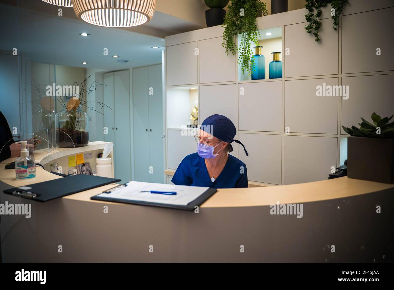 Dentist at the reception of her dental clinic Stock Photo Alamy
