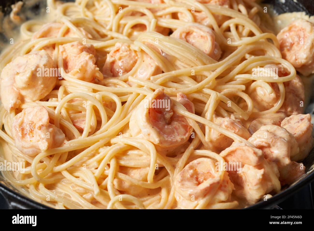 Pasta with shrimp cream sauce in frying pan, spaghetti with seafood