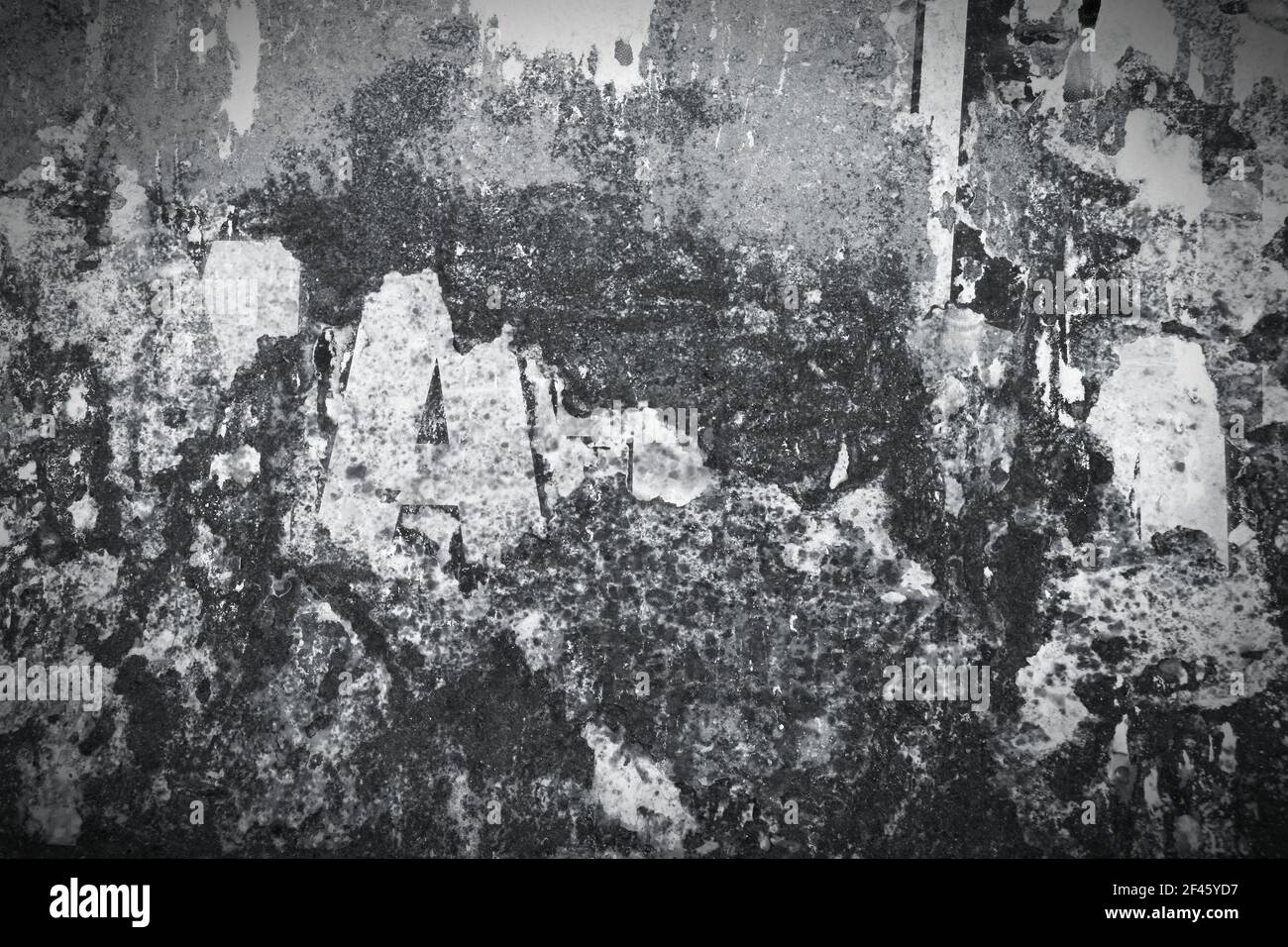 Old, rusty metal wall with remains of old posters and advertisements