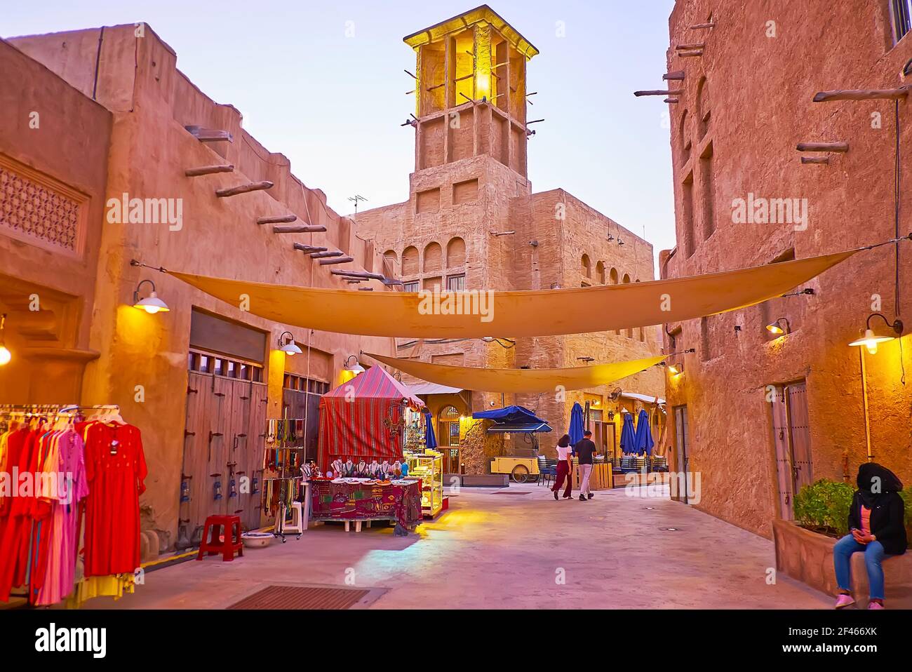 The scenic adobe street of Al Fahidi with small tourist market stalls, offering souvenirs, garment, traditional jewelries, Dubai, UAE Stock Photo