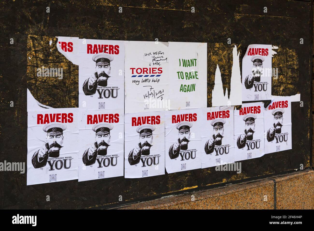 Ravers your country needs you, I want to rave again, Tories very little helps - torn posters on wall at Bournemouth, Dorset UK in March Stock Photo