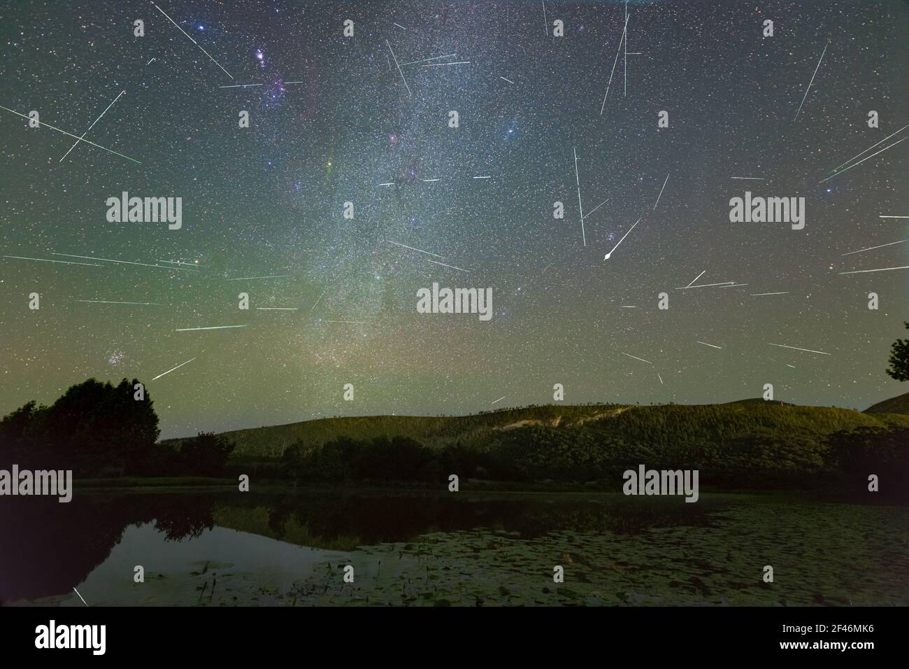 A breathtaking view of Perseids meteor shower over the pond Stock Photo - Alamy