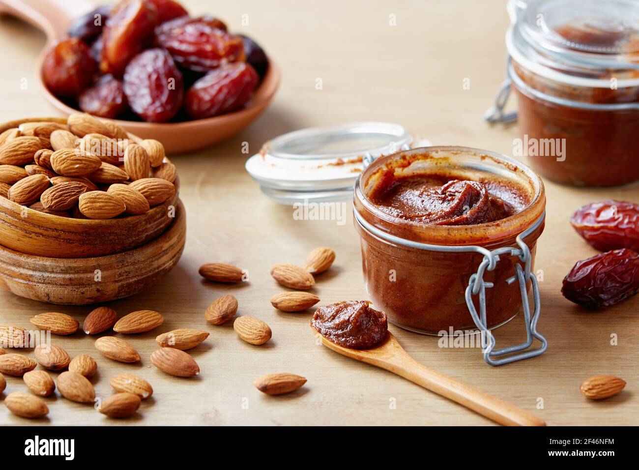 Vegan date spread with almonds (sugar-free). Jar of homemade vegan date spread. Stock Photo