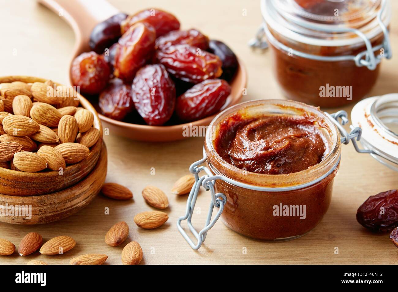 Vegan date spread with almonds (sugar-free). Jar of homemade vegan date spread. Stock Photo