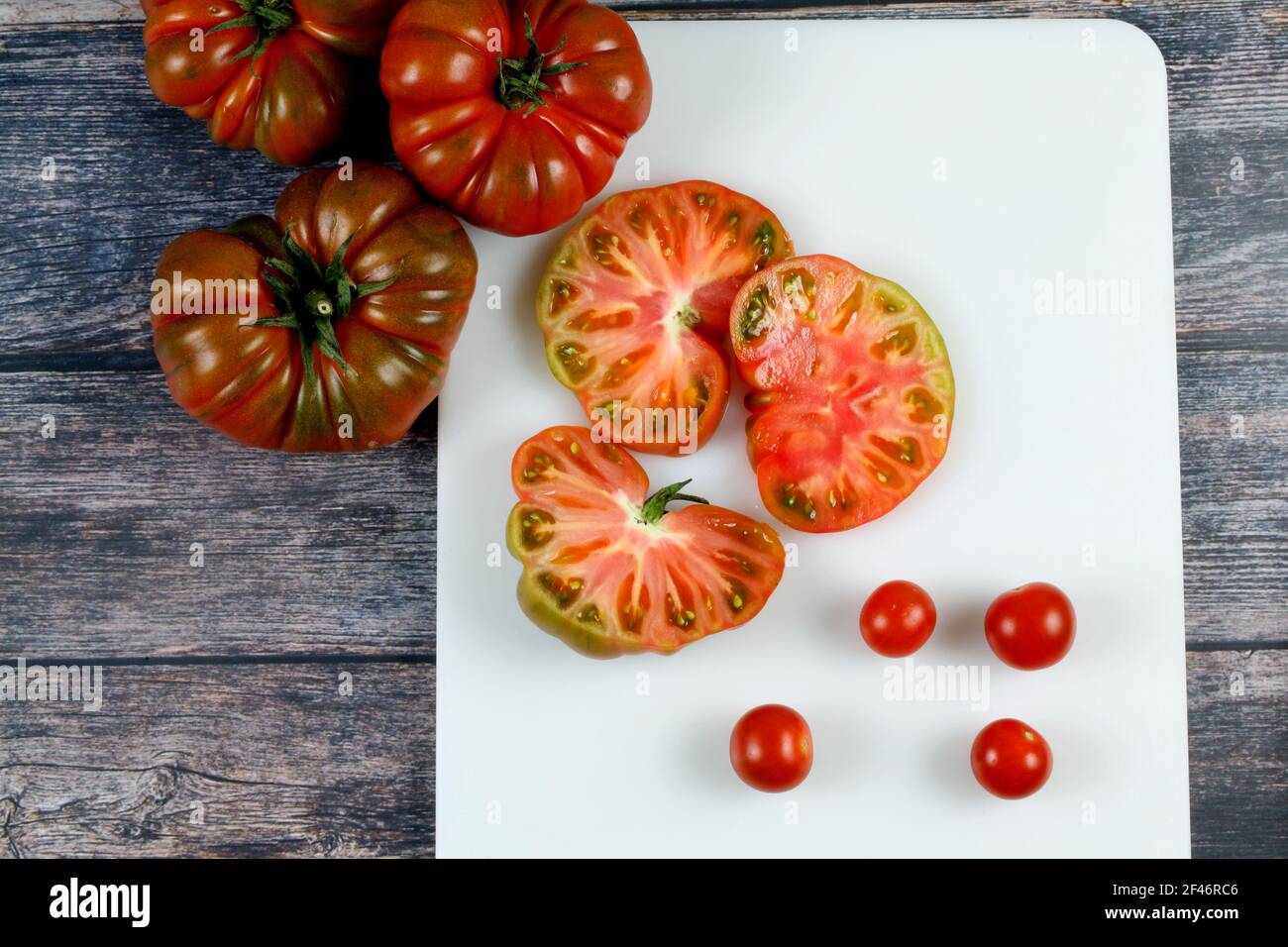 A top view of Brandywine and cherry tomatoes on cutting board Stock ...