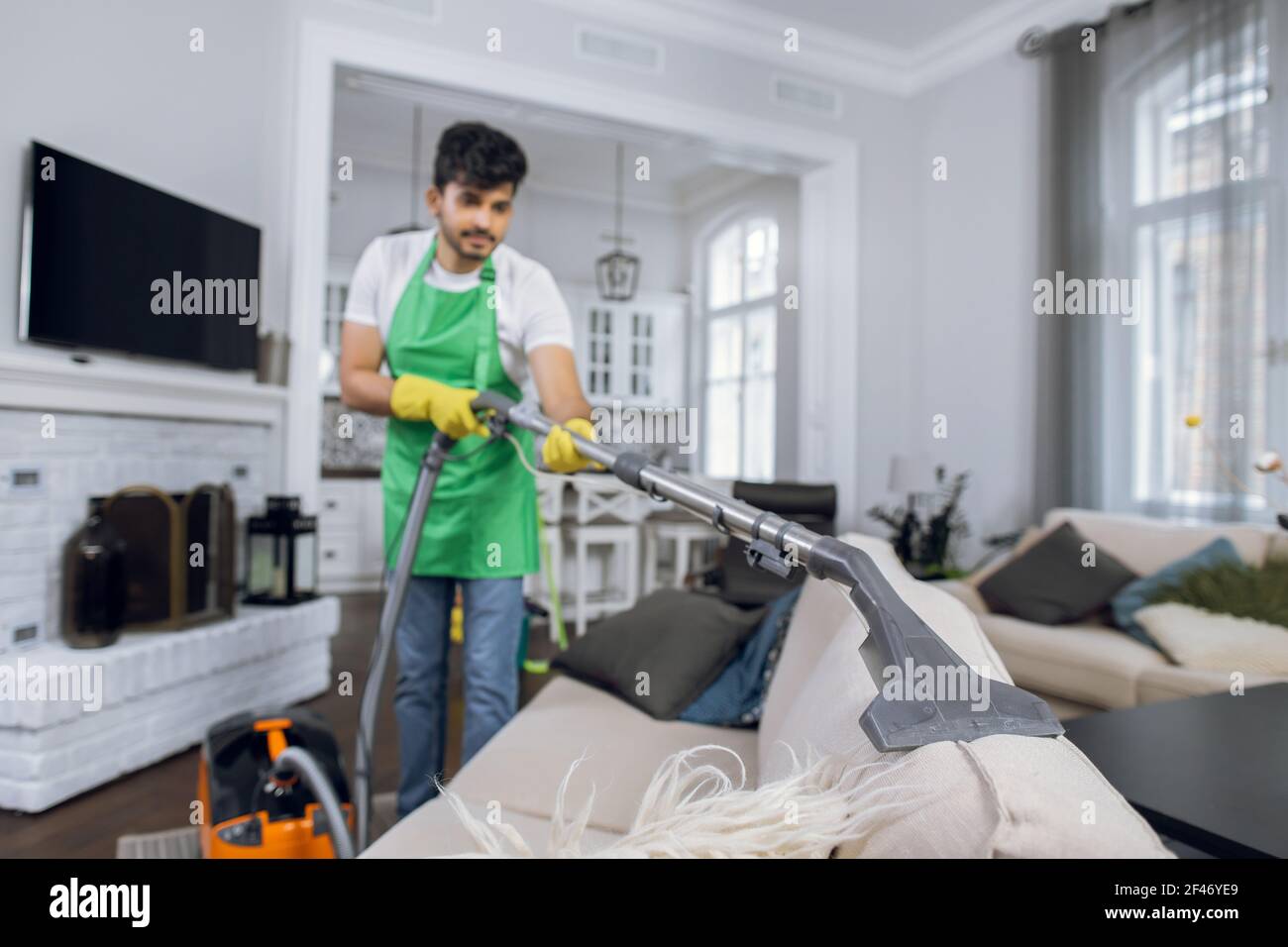young indian man removing dust from 