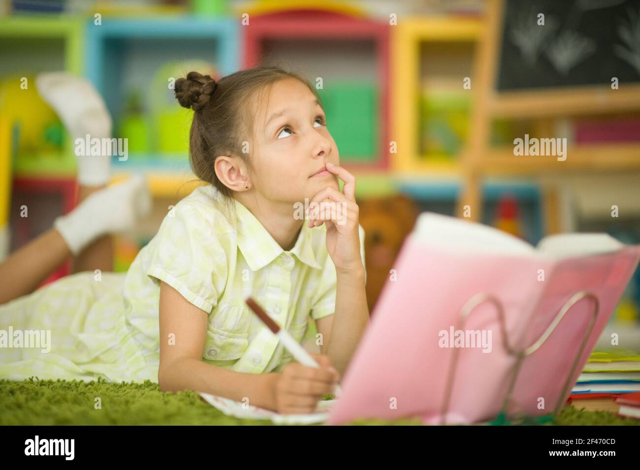 Portrait of cute little girl studying at home Stock Photo - Alamy