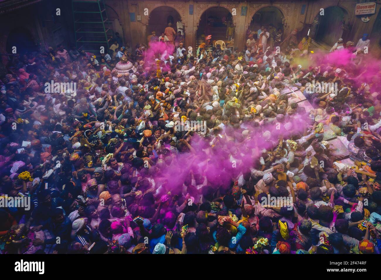 March 1, 2018: Vibrant colours whirled in air at Bankey Bihari Temple in  Vrindavan, Mathura, India. Holi is an ancient Hindu festival, aka festival o Stock Photo