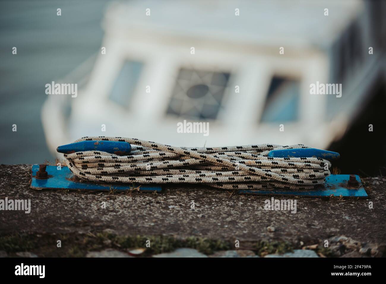 A closeup shot of old weathered rusty bollard on a pier Stock Photo