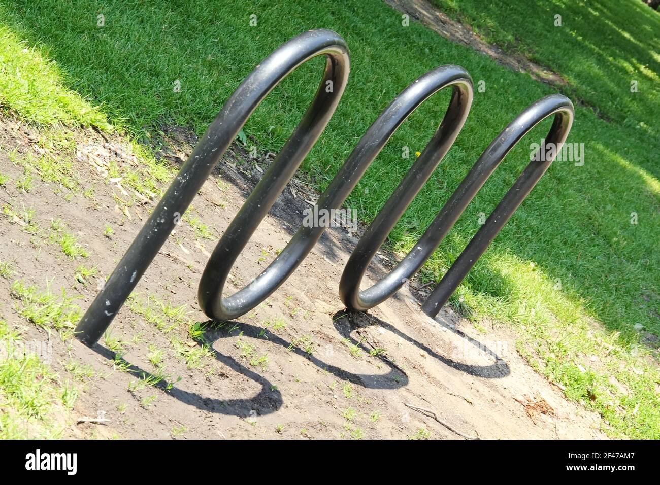 Horizontal view of an empty  bicycle rack in the park that resembles an electrical sine wave or frequency Stock Photo