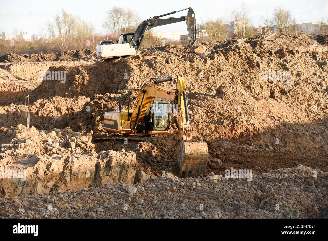 Excavator dig the trenches at a construction site. Trench for laying ...