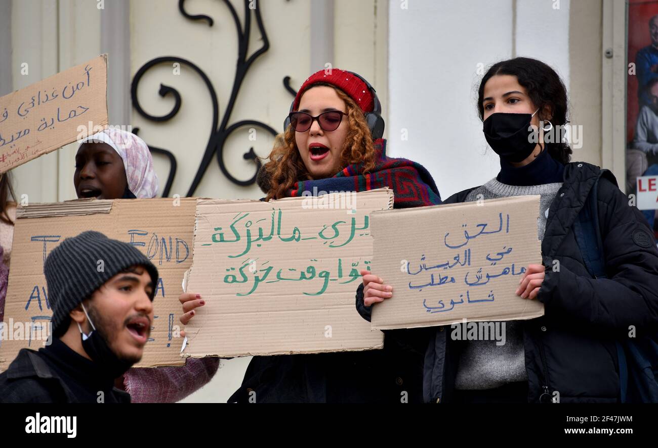 Protesters chanting slogans while holding placards expressing their ...