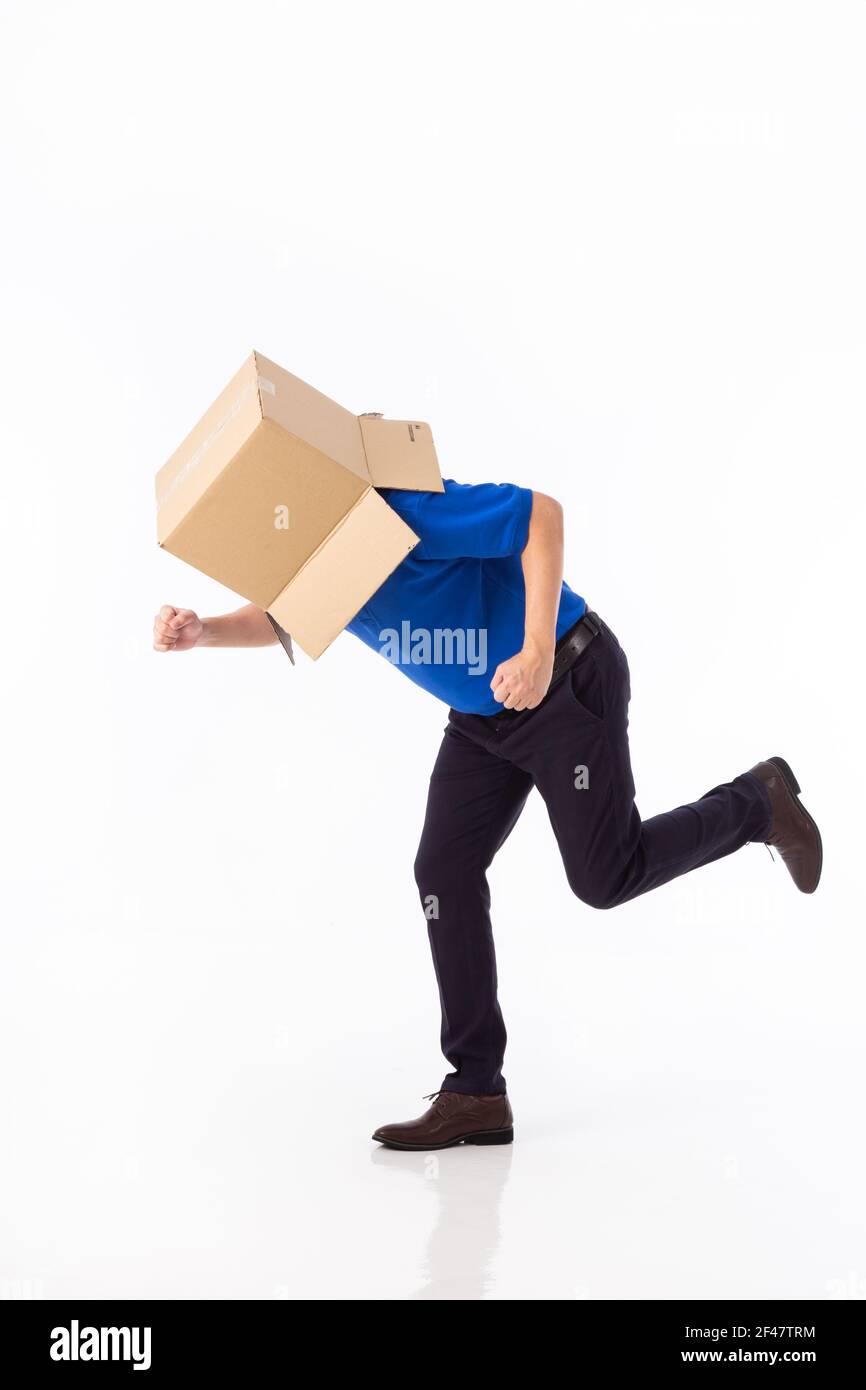 man in a bluer T-shirt with a cardboard box on his head makes a gesture ...