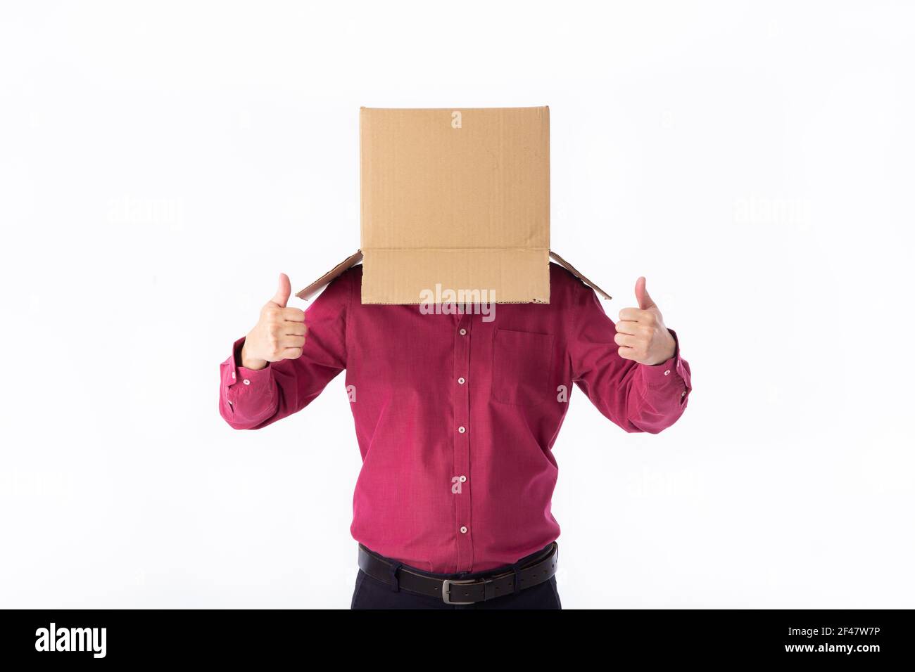 man in a red shirt with a cardboard box on his head makes a gesture ...