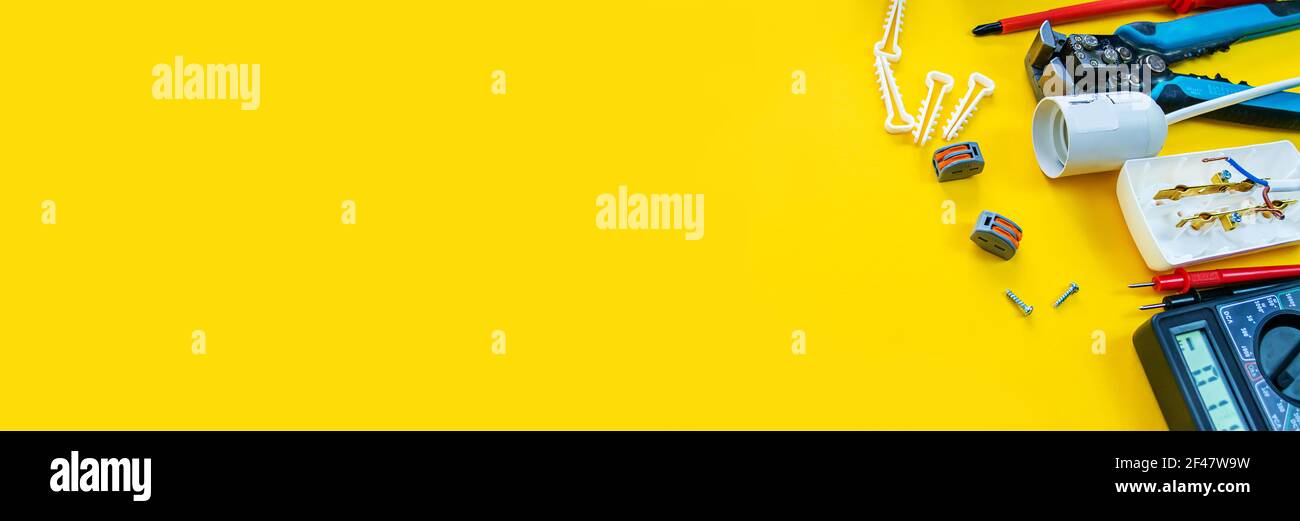 Electrical installation measuring instruments tools on a yellow background with copy space. place for text. Selective focus Stock Photo