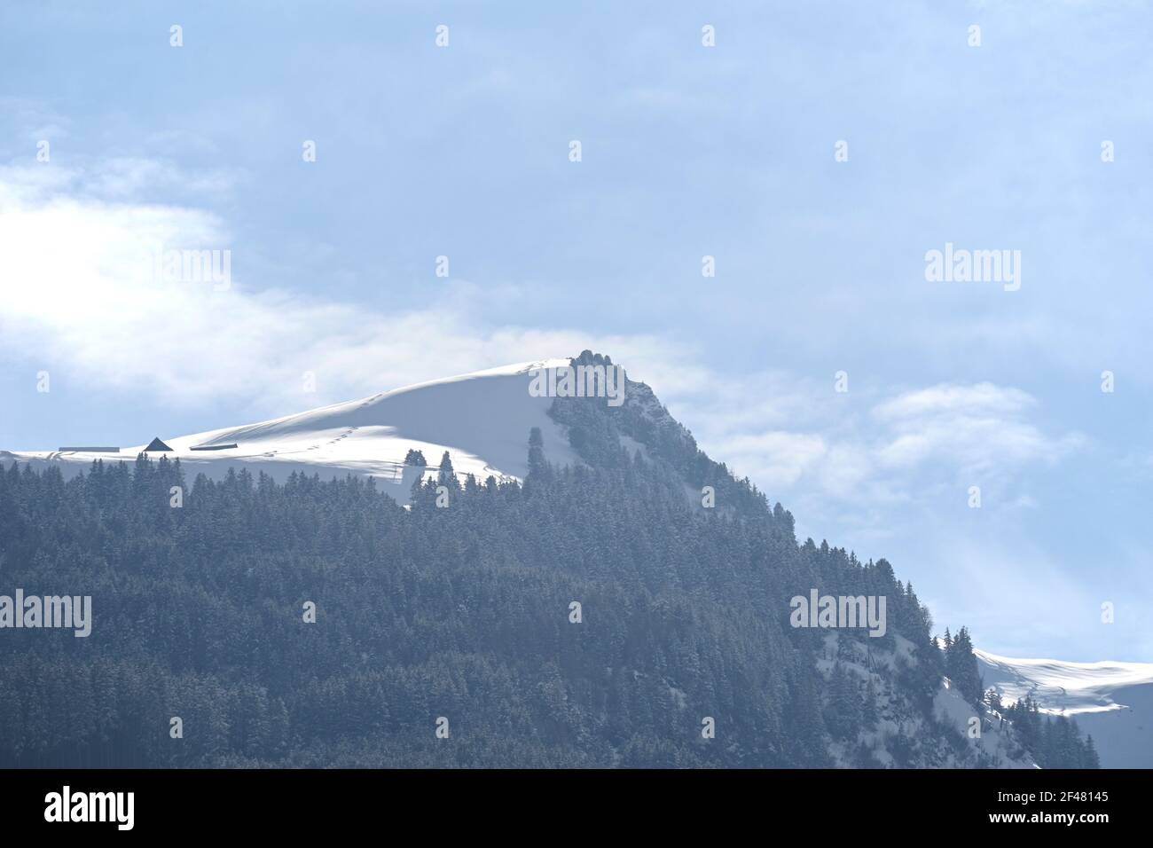 The tip of a snowy mountain at a sunny day Stock Photo