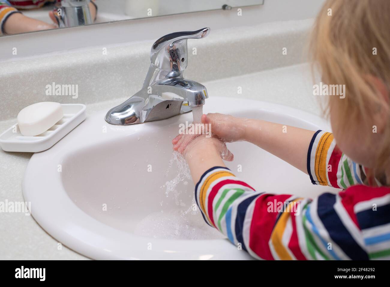 Little child washing hands with soap in the bashroom Stock Photo - Alamy
