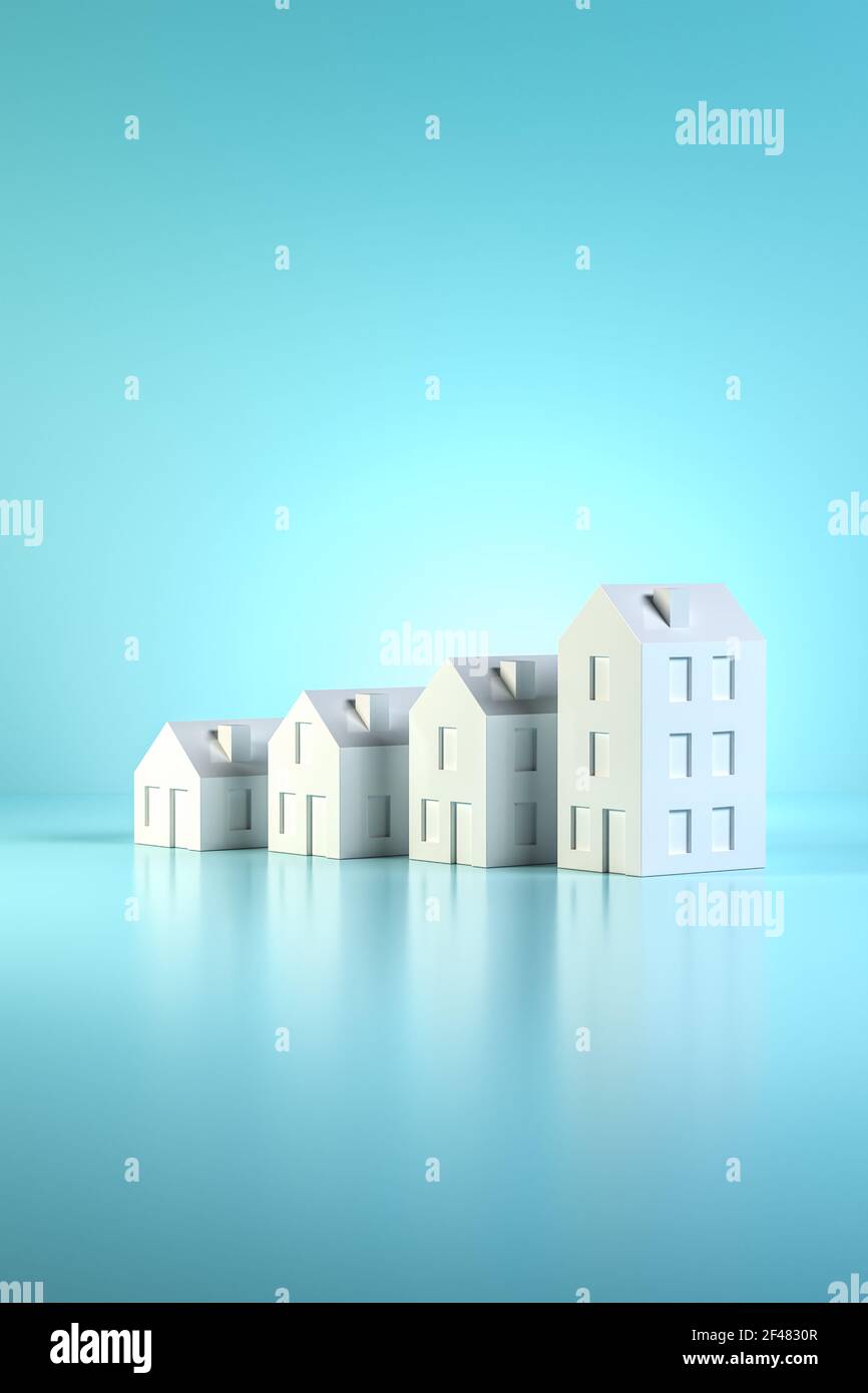 Which size of house can you afford? Concept shot: four differently sized models of houses on a blue background. Copy space available. Stock Photo